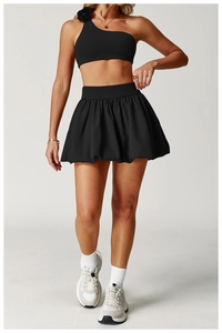 Detail of black sports skirt and one-shoulder top with 3D floral accent decoration
