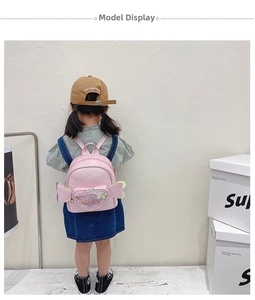 Pink glitter backpack for girls featuring heart pocket and decorative wings detail