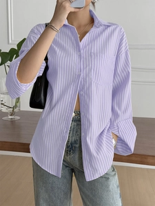 Detailed view of casual purple and white striped loose shirt with chest pocket and buttons