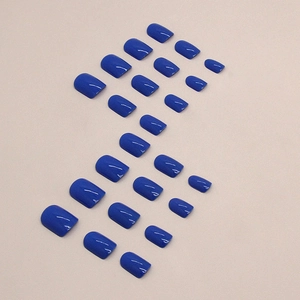 Short square royal blue press-on nails set with glossy finish on neutral background