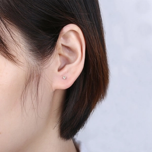 S925 sterling silver minimalist round ball stud earring worn by a model on ear lobe