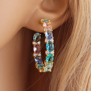 Elegant gold hoop earrings featuring vibrant multi-color gemstones and sparkling zirconia