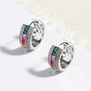 Close-up of silver earrings featuring vibrant multi-color cubic zirconia geometric stones