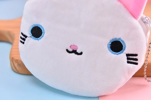 Close-up of soft white plush cat coin purse with blue embroidered eyes and pink ears