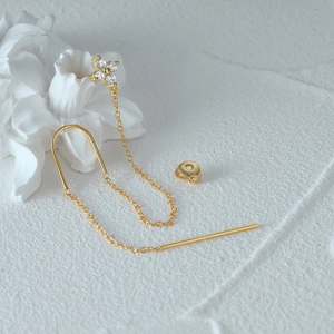Macro shot of S925 sterling silver tassel earring with clover zircon detail