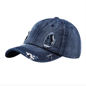 Distressed dark blue denim baseball cap with vintage washed style and ripped details