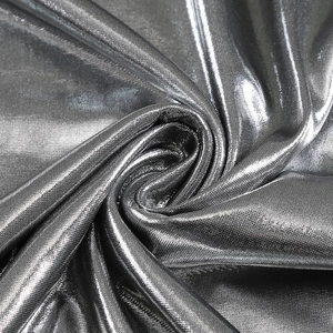 Macro detail of shimmering silver metallic fabric showing smooth texture and drape