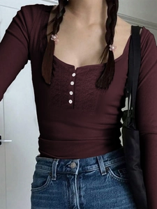 Detail of burgundy Y2K long sleeve top with lace stitching and white button accents