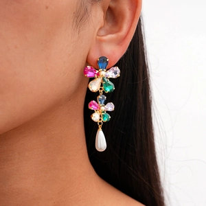 Detail of flower earrings with colorful rhinestones and hanging teardrop pearl