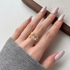 Detailed close-up of a S925 silver gold butterfly ring with sparkling zircon stones