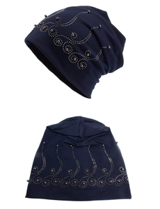 Detail of dark blue beanie featuring intricate rhinestone patterns and knitted texture