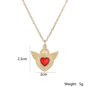 Detail of gold winged heart necklace pendant showing dimensions 2.3cm by 2cm and weight 5g