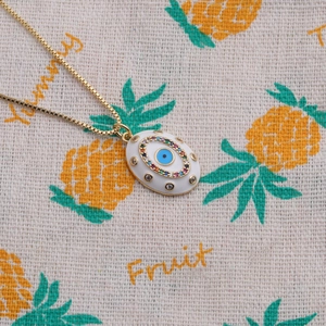 Detailed close-up of a gold-plated evil eye pendant necklace with colorful zircons