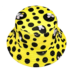 Bright yellow bucket hat with black polka dots and playful cartoon mouse patterns