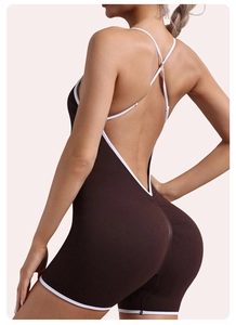 Close-up of cross-back straps and white contrast trim on brown ribbed yoga romper