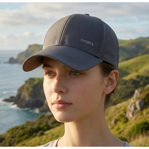Detail of dark grey breathable mesh baseball cap with laser-cut holes and SPORTS print