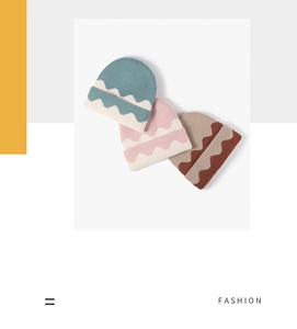 Flat lay of warm knitted beanies in teal, pink, and brown with wave patterns