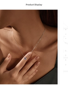 Close-up of a sparkling round-cut zircon pendant on a S925 silver necklace on model