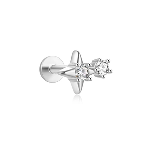 Detail of silver star piercing earring with two round cubic zirconia stones on white back