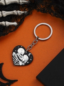 Halloween heart keychain with skull couple pendant on orange textured background with bats
