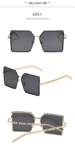 Detail view of large grey square sunglasses with golden metal chain temples on white background