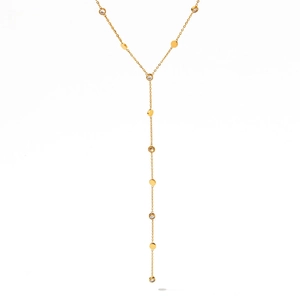 Detail view of the golden Y-shaped tassel necklace with polished disks and zircon stones