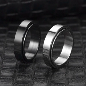Close-up of minimalist black and silver stainless steel spinning bands for couples