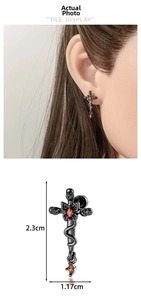 Close-up of gothic snake cross earrings with red stones and 2.3cm height dimensions