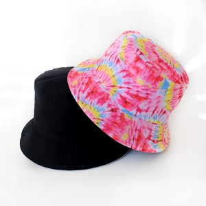 Detail showing solid black and vibrant tie-dye reversible bucket hat fabric texture