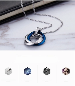 Close-up of interlinked stainless steel rings pendant with blue accent and small crystals