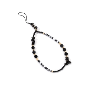 Detail of handmade black beaded phone strap with acrylic crystals and gold accents