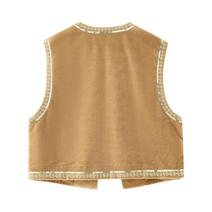 Close-up of velvet sequined vest with gold embroidery trim on a white background