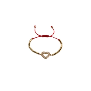 Adjustable red rope bracelet with a gold heart-shaped pendant paved in clear zircon