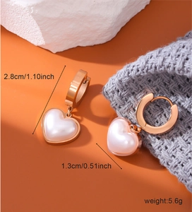 Detail shot of heart pearl earrings in rose gold with measurements 2.8cm and 5.6g weight