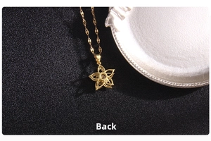Detailed back view of golden clover pendant showing intricate metal craftsmanship