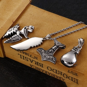 Silver Viking pendant collection featuring skull, wing, and hammer on a vintage box