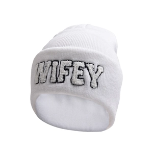 Close-up of white knit beanie featuring detailed WIFEY plush embroidery and texture