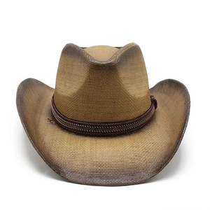 Detail of western straw cowboy hat featuring ethnic style woven band and distressed finish