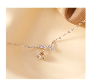 Detailed macro view of a rose gold flower pendant necklace with shimmering zircon stones