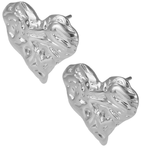 Macro detail of heart-shaped silver earrings with unique liquid lava metal texture