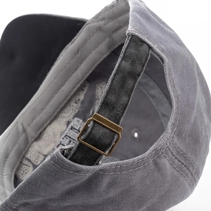 Close-up of vintage washed cotton baseball cap with adjustable metal buckle on back