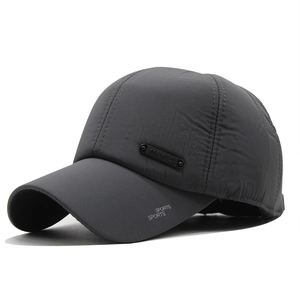 Detailed macro view of gray baseball cap featuring metal plate and sports embroidery
