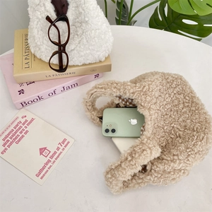 Detail of lamb wool tote bags in creamy white and oatmeal with brown checkered lining