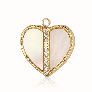 Macro view of a gold heart pendant with shell inlay and a sparkling center gemstone