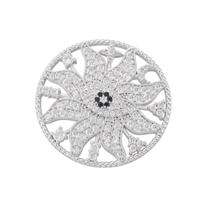 Detailed view of silver sun flower pendant with sparkling white and black crystals
