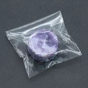 Purple natural agate crystal sphere base stand in clear protective OPP bag packaging