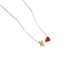 Golden necklace featuring a red enamel heart pendant and a metal letter K charm on thin chain
