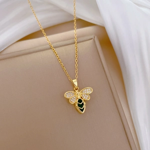 Elegant gold bee necklace with green gemstone and sparkling zircon wings for women