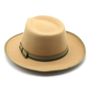 Detail of wool felt fedora hat featuring a green striped ribbon and metal buckle ornament