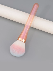 Macro detail of fluffy gradient bristles and sparkling glitter handle on makeup brush